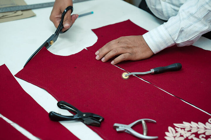 Hand cutting fabric at Taroob